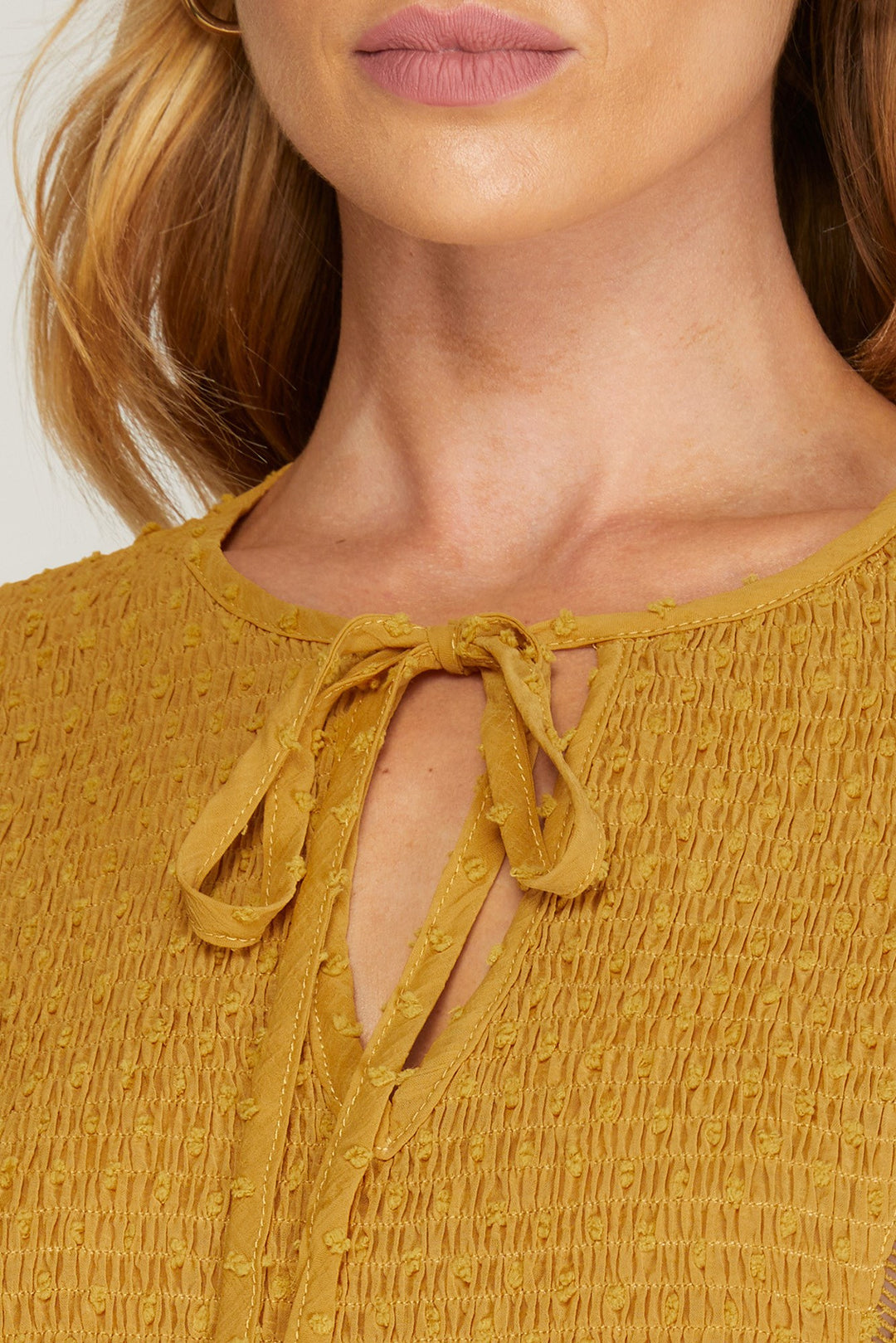 LONG SLEEVE SWISS DOT DRESS WITH SMOCKED DETAIL AND FRONT NECK TIE