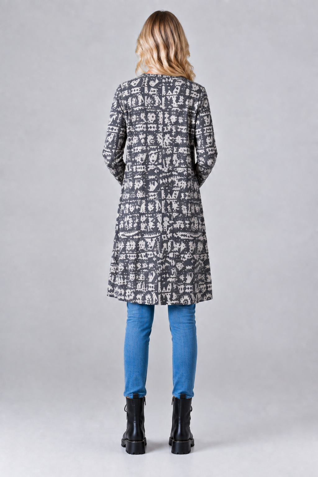Aztec print cardigan, blonde model, full back pose, studio background