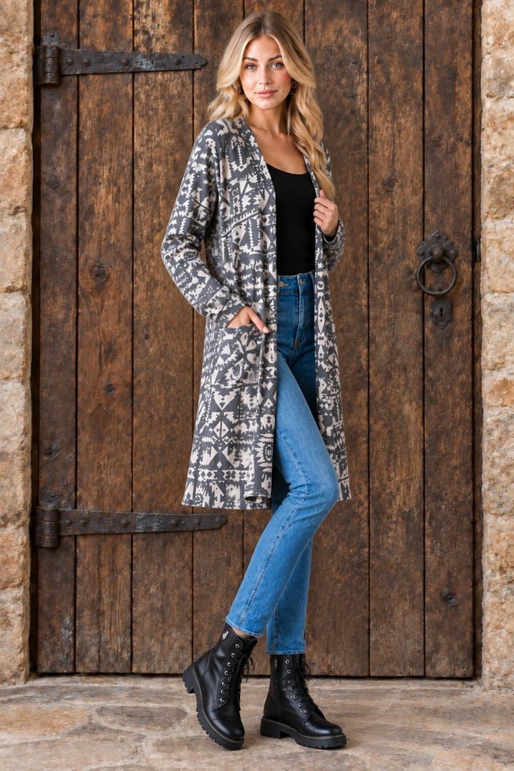 Aztec print cardigan, blonde model, half-side pose face forward, rustic door background
