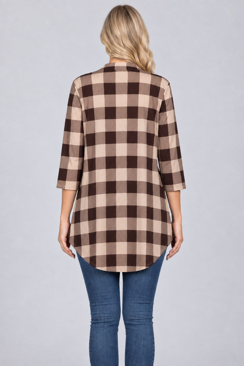 Back studio view of a blonde model wearing the beige-and-brown plaid tunic with blue jeans