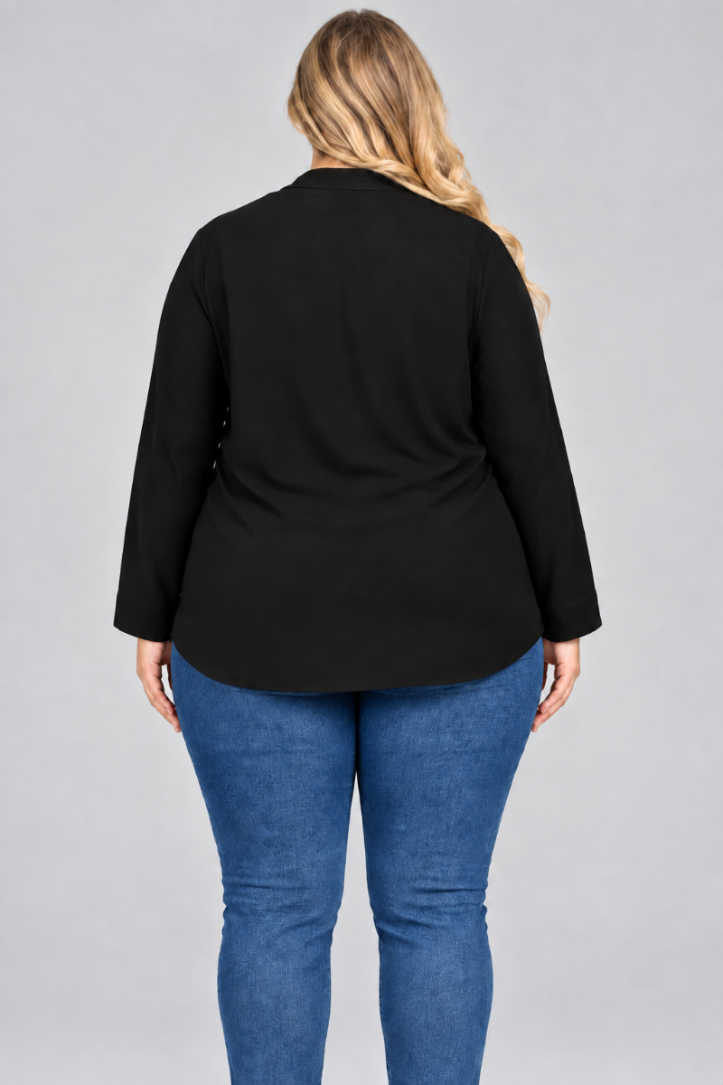 Back studio view of a plus-size blonde model wearing a black blouse and pants