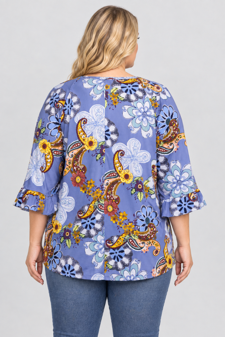 Back studio view of a plus-size blonde model wearing the periwinkle floral-paisley blouse and blue jeans