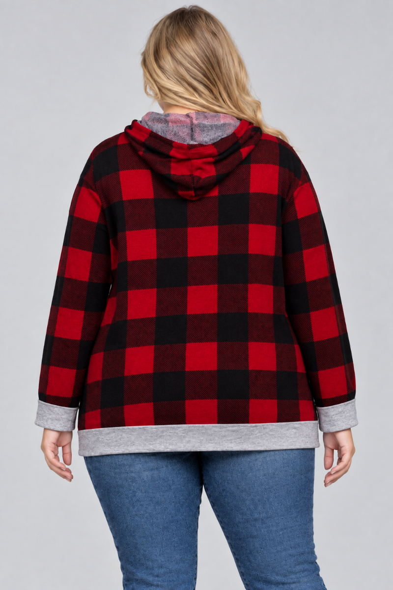 Back studio view of a plus-size blonde model wearing the red-and-black plaid hoodie and blue jeans