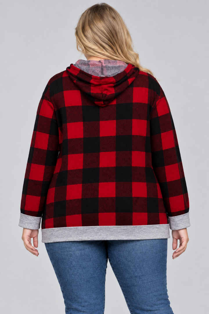 Back studio view of a plus-size blonde model wearing the red-and-black plaid hoodie and blue jeans