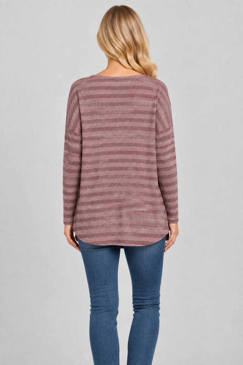 Back studio view of the blonde model wearing the mauve striped top and blue jeans