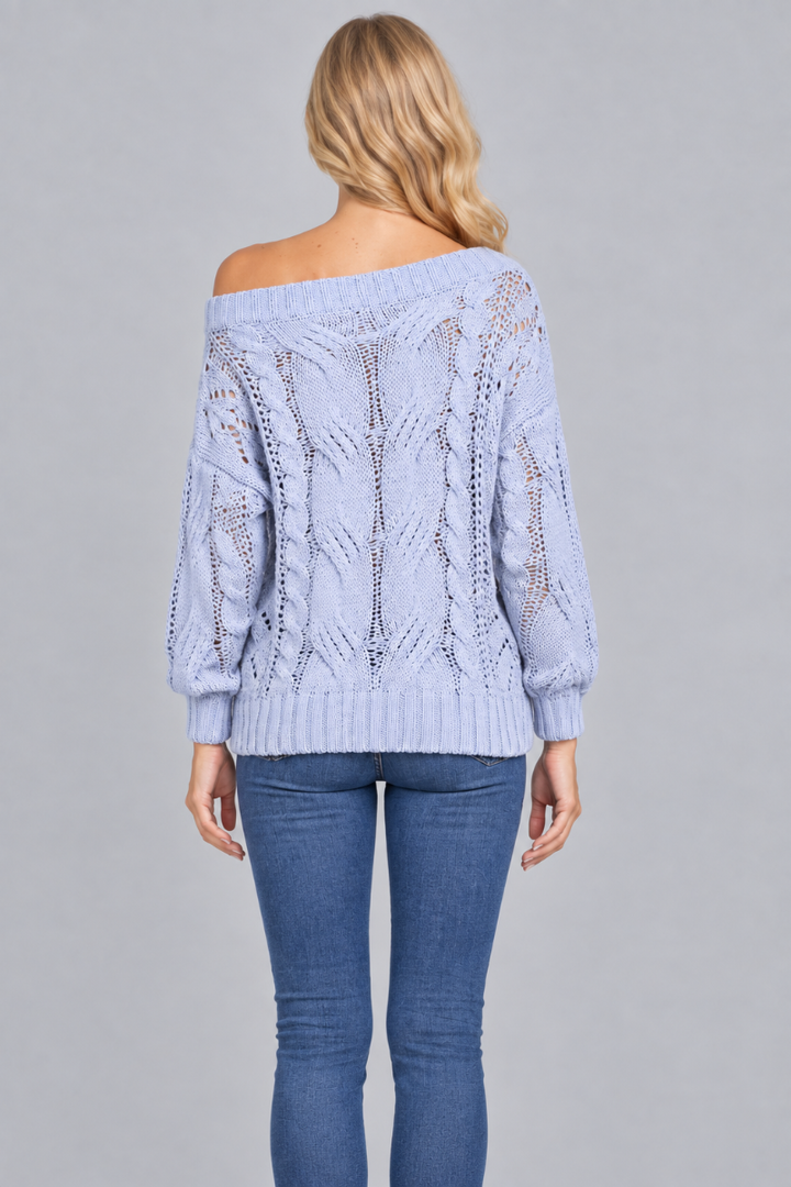 Back studio view of the blonde model wearing the pale-blue off-shoulder open-knit sweater and blue jeans
