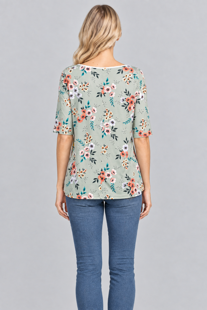 Back studio view of the blonde model wearing the sage floral top and denim jeans