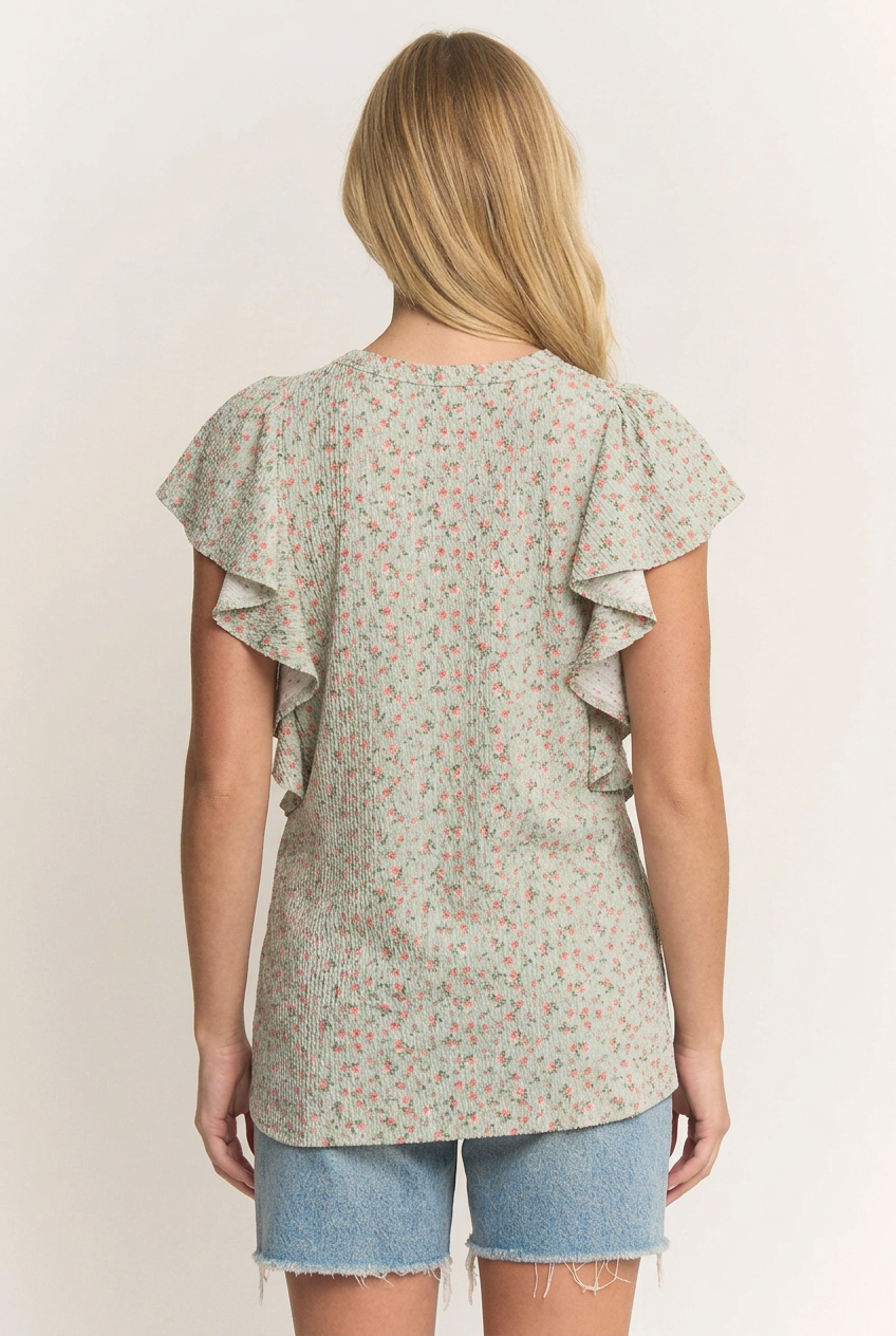 Back view of the blonde model wearing the floral ruffle top