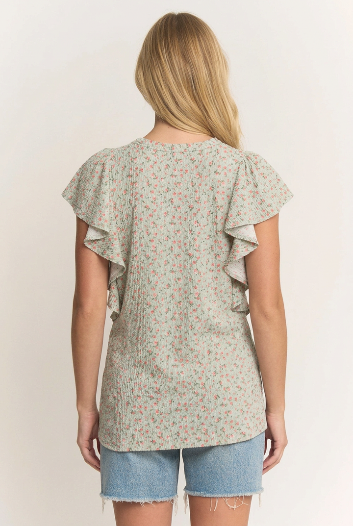 Back view of the blonde model wearing the floral ruffle top