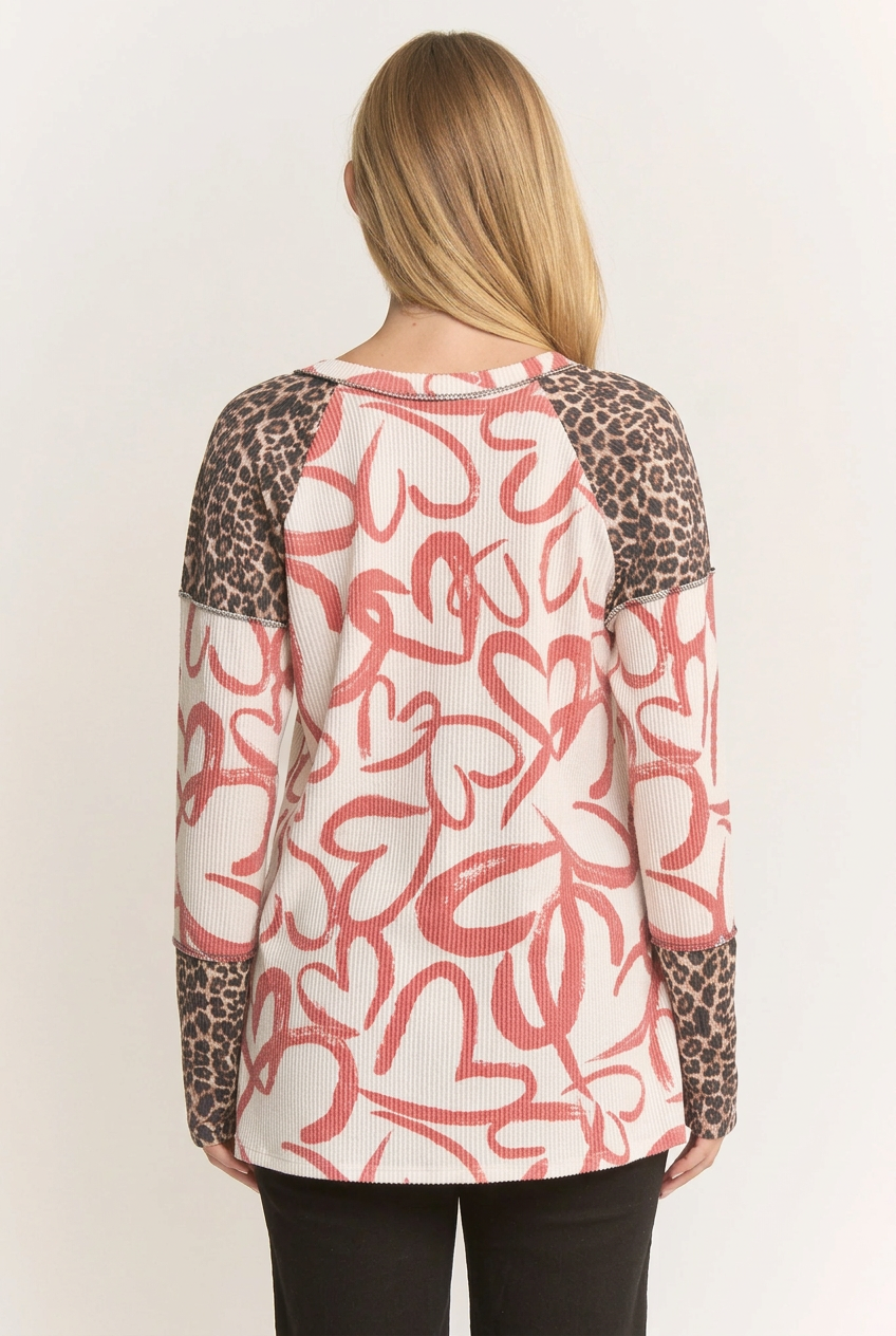 Back view of the blonde model wearing the heart-and-leopard top