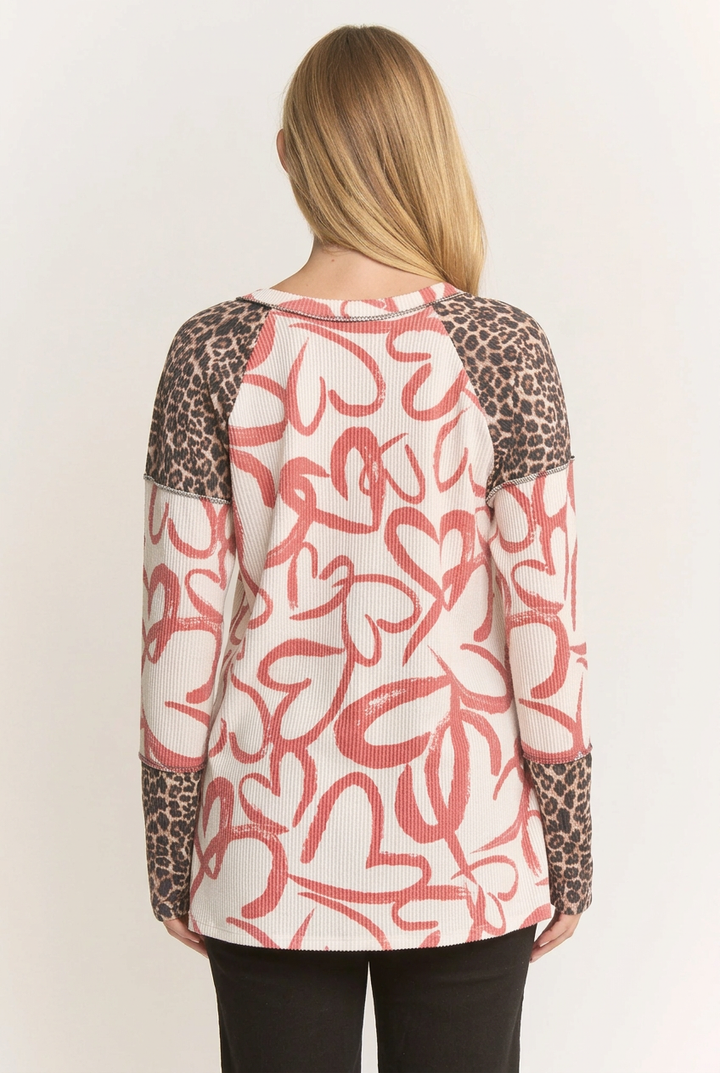 Back view of the blonde model wearing the heart-and-leopard top