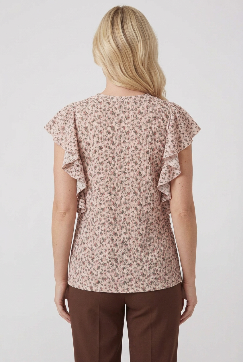 Back view of the blonde model wearing the pink floral top and brown pants