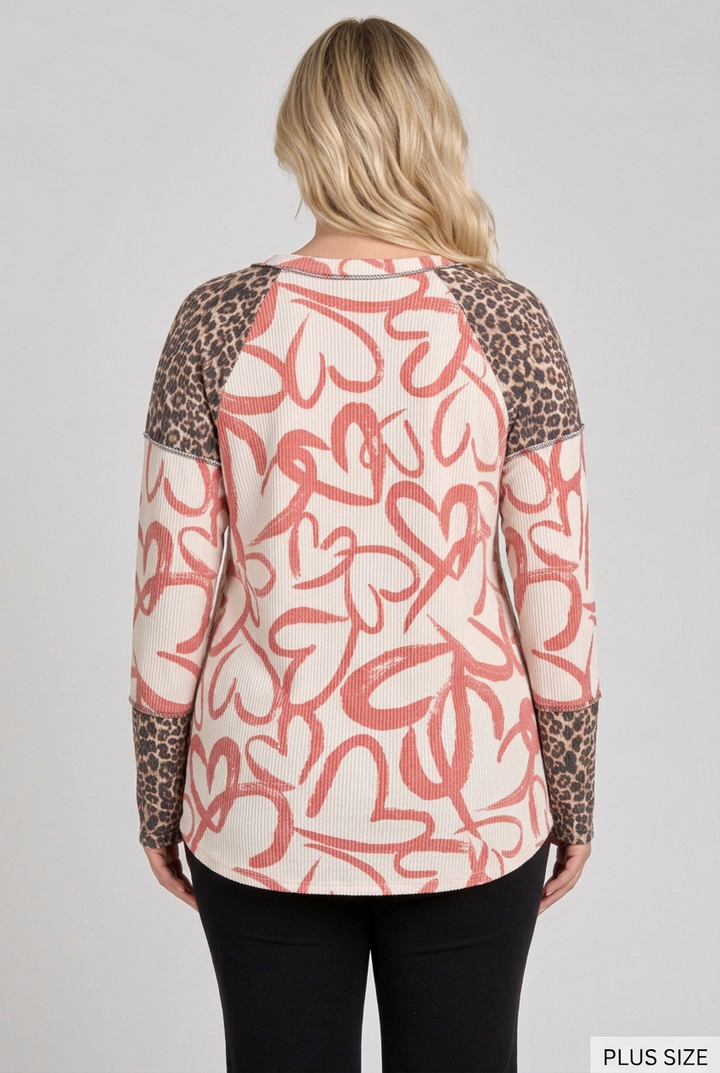 Back view of the plus-size blonde model wearing the heart-and-leopard top