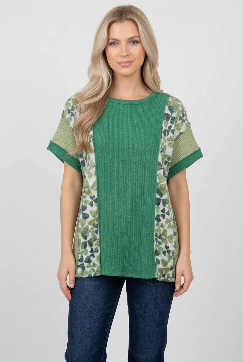 Blonde model wearing the green butterfly-panel top with jeans