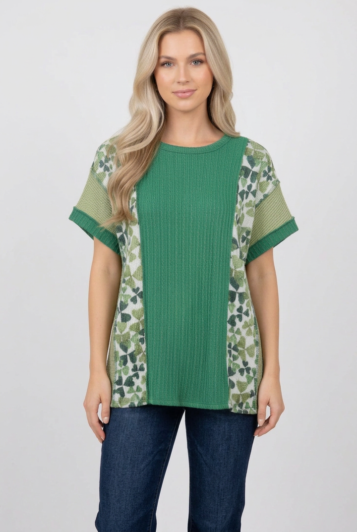 Blonde model wearing the green butterfly-panel top with jeans