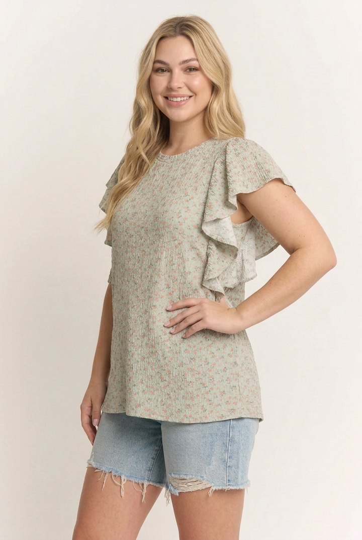 Blonde model with the new face in a side pose wearing the floral ruffle top