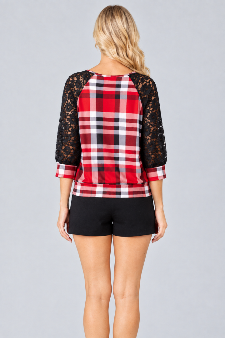 Full-back studio view of the blonde model wearing the red plaid top with black lace sleeves and black shorts