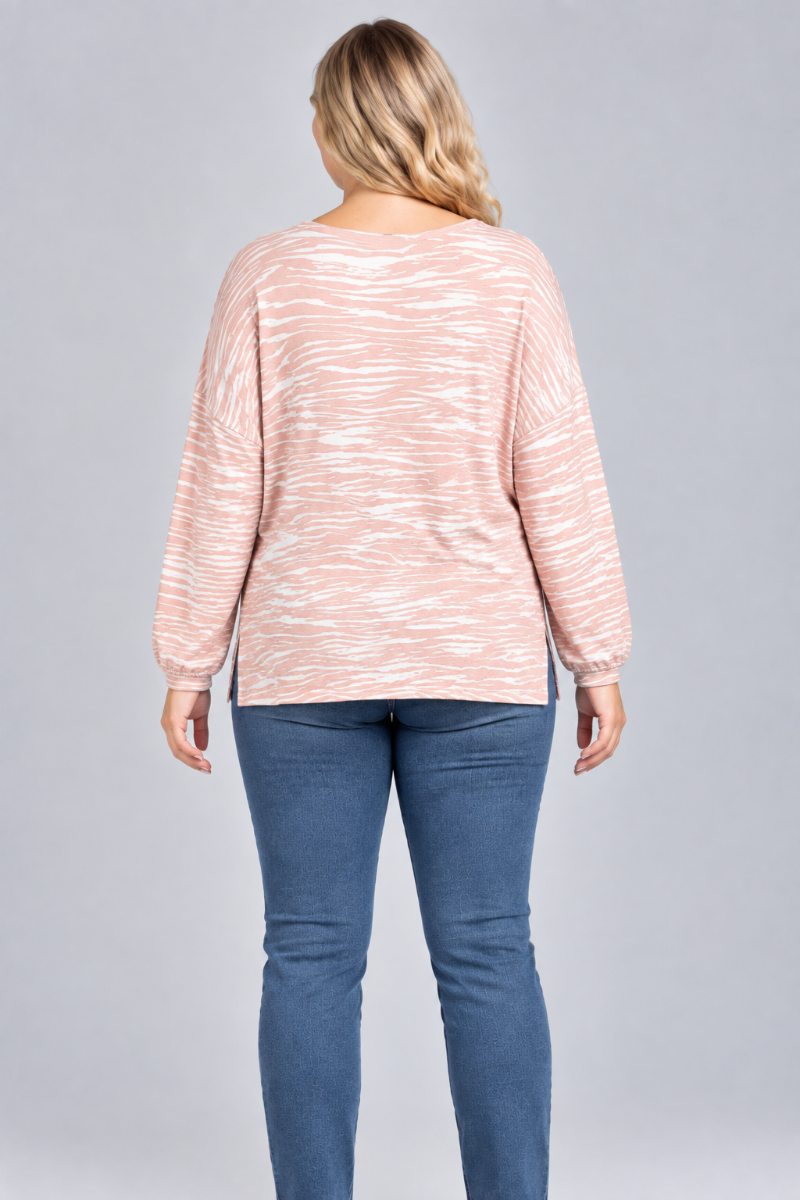 Full-back studio view of the blonde XL model wearing the blush striped top and blue jeans
