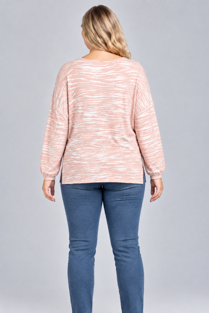 Full-back studio view of the blonde XL model wearing the blush striped top and blue jeans