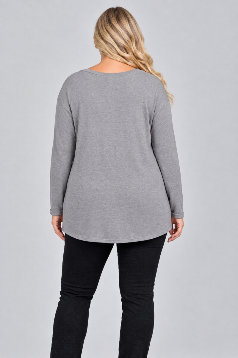 Full-back studio view of the blonde XL model wearing the gray top and black pants