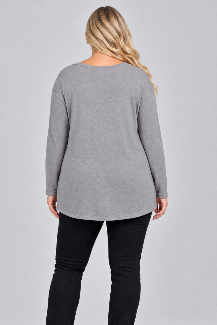 Full-back studio view of the blonde XL model wearing the gray top and black pants