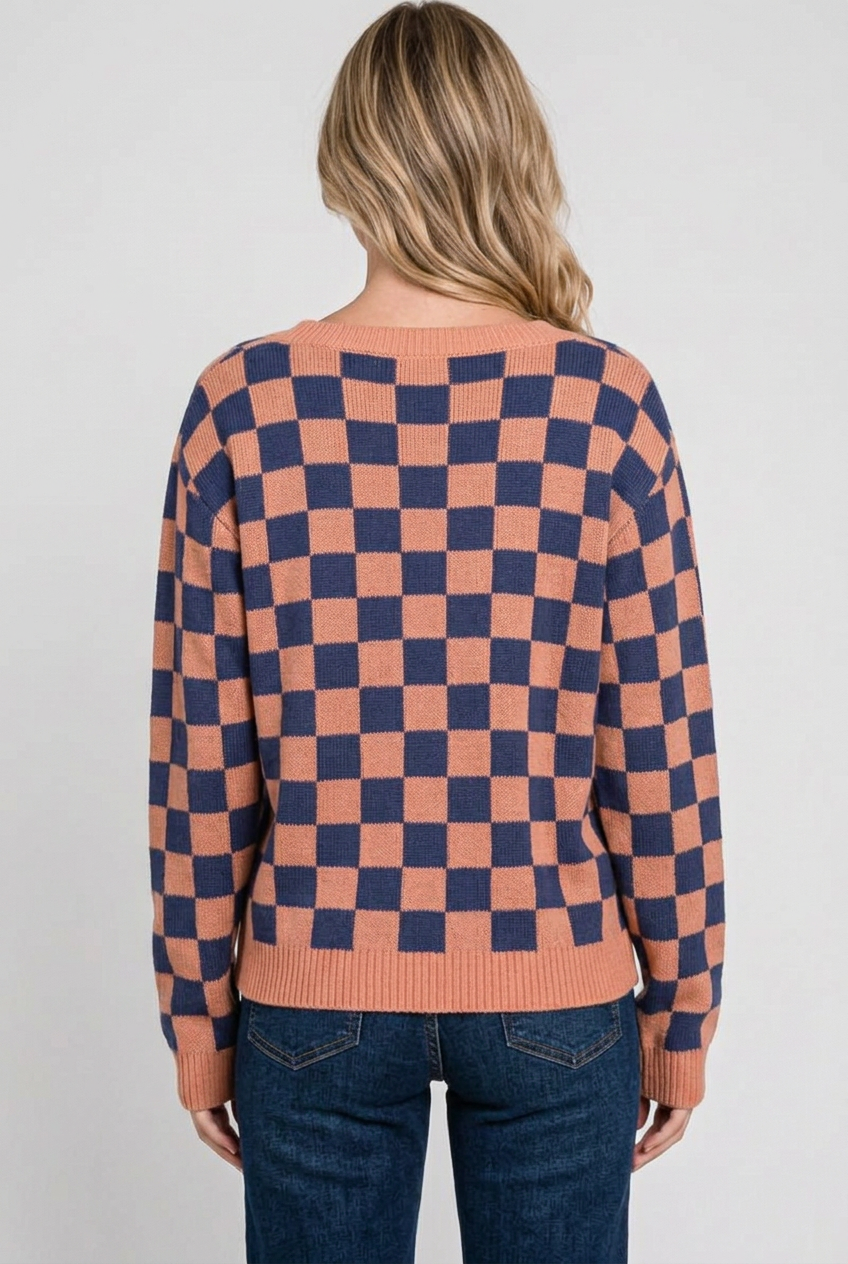 Full-back studio view of the checkerboard sweater with dark-wash jeans