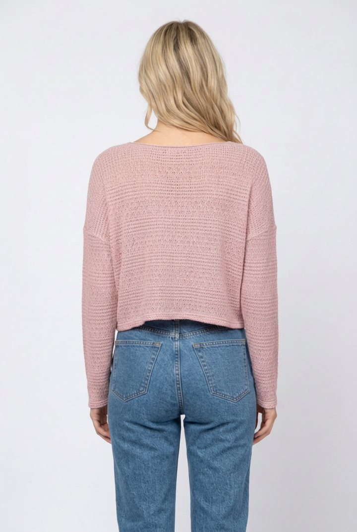 Full-back studio view of the dusty-pink knit sweater with denim jeans