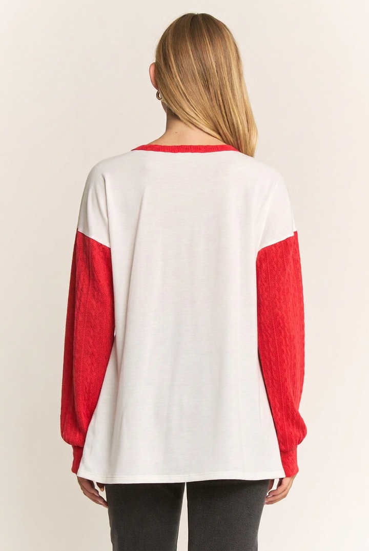 Full-back studio view of the ivory top with red sleeves