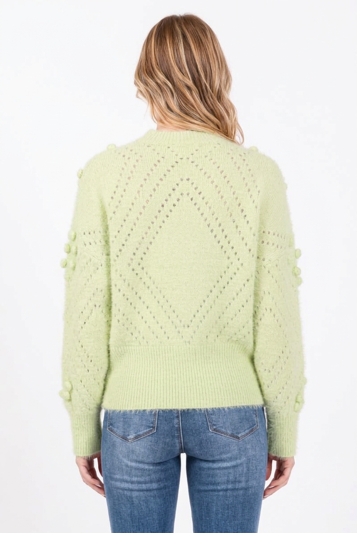 Full-back studio view of the pale green diamond-knit sweater