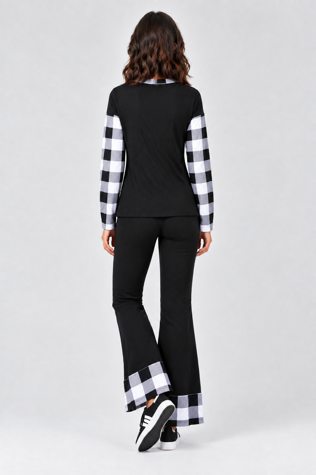 Full-body studio back view, black outfit with black-and-white plaid accents, black sneakers with white details
