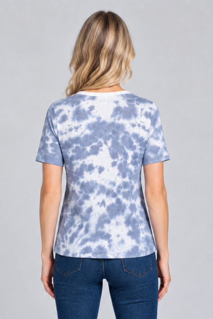 Full-body studio back view, blonde model in blue-and-white tie-dye top and dark jeans