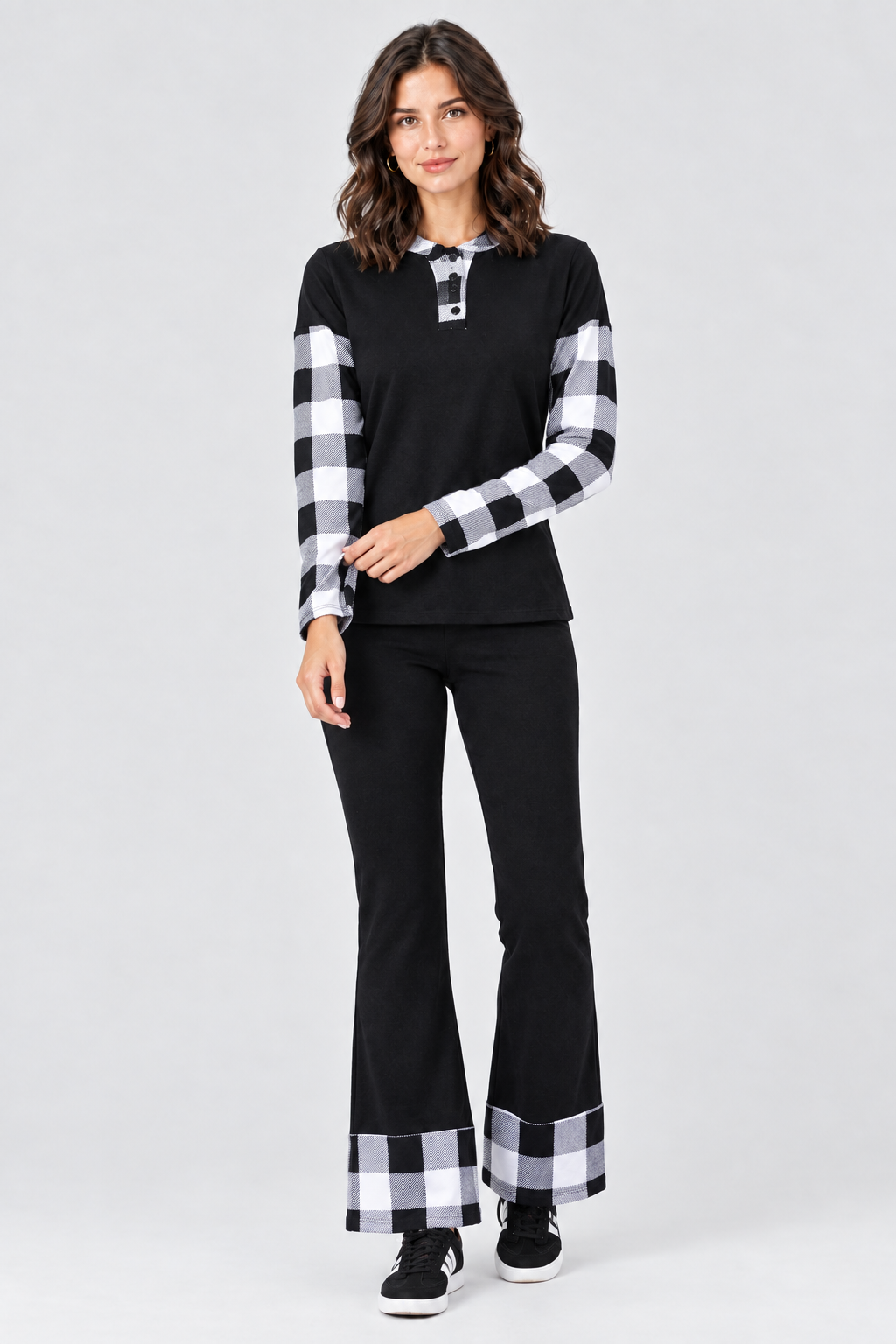 Full-body studio front view, black outfit with black-and-white plaid accents, black sneakers with white details