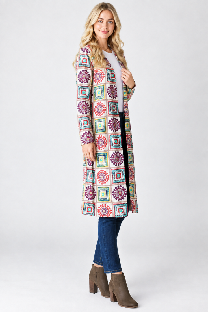 Geometric print cardigan, blonde model, side pose, face forward, studio background