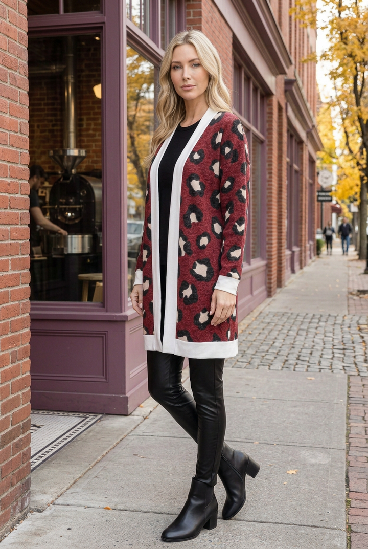 Half-side lifestyle pose wearing the burgundy leopard cardigan