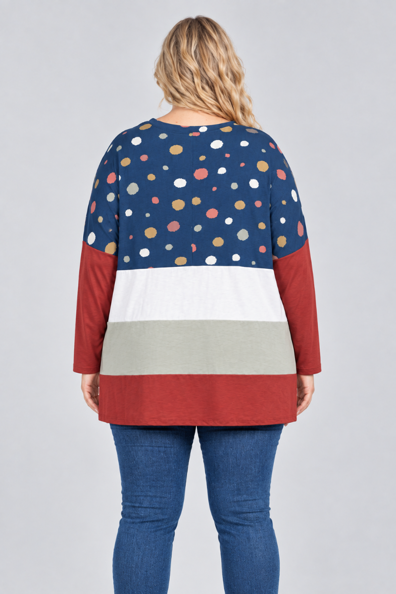 Hat-free studio back view of blonde model in navy dotted color-block tunic and blue jeans
