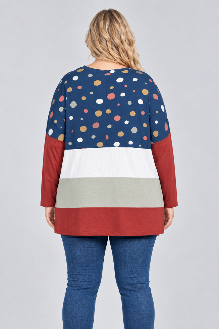 Hat-free studio back view of blonde model in navy dotted color-block tunic and blue jeans