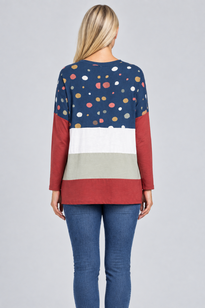 Hat-free studio back view of blonde model in navy dotted color-block tunic and jeans