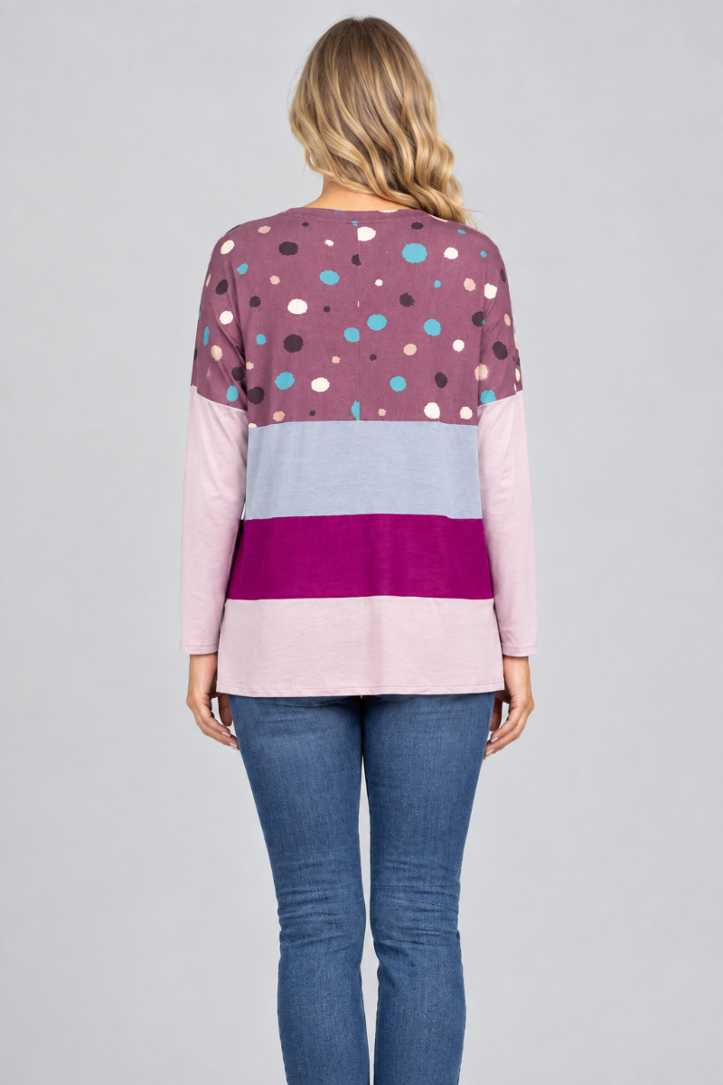 Hat-free studio back view of blonde model in plum dotted color-block tunic and jeans