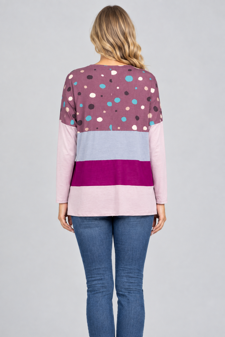 Hat-free studio back view of blonde model in plum dotted color-block tunic and jeans