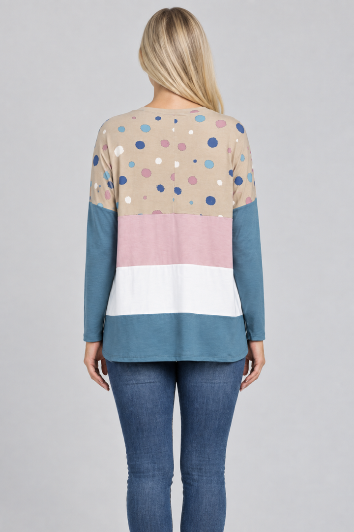 Hat-free studio back view of blonde model in taupe dotted color-block tunic and jeans