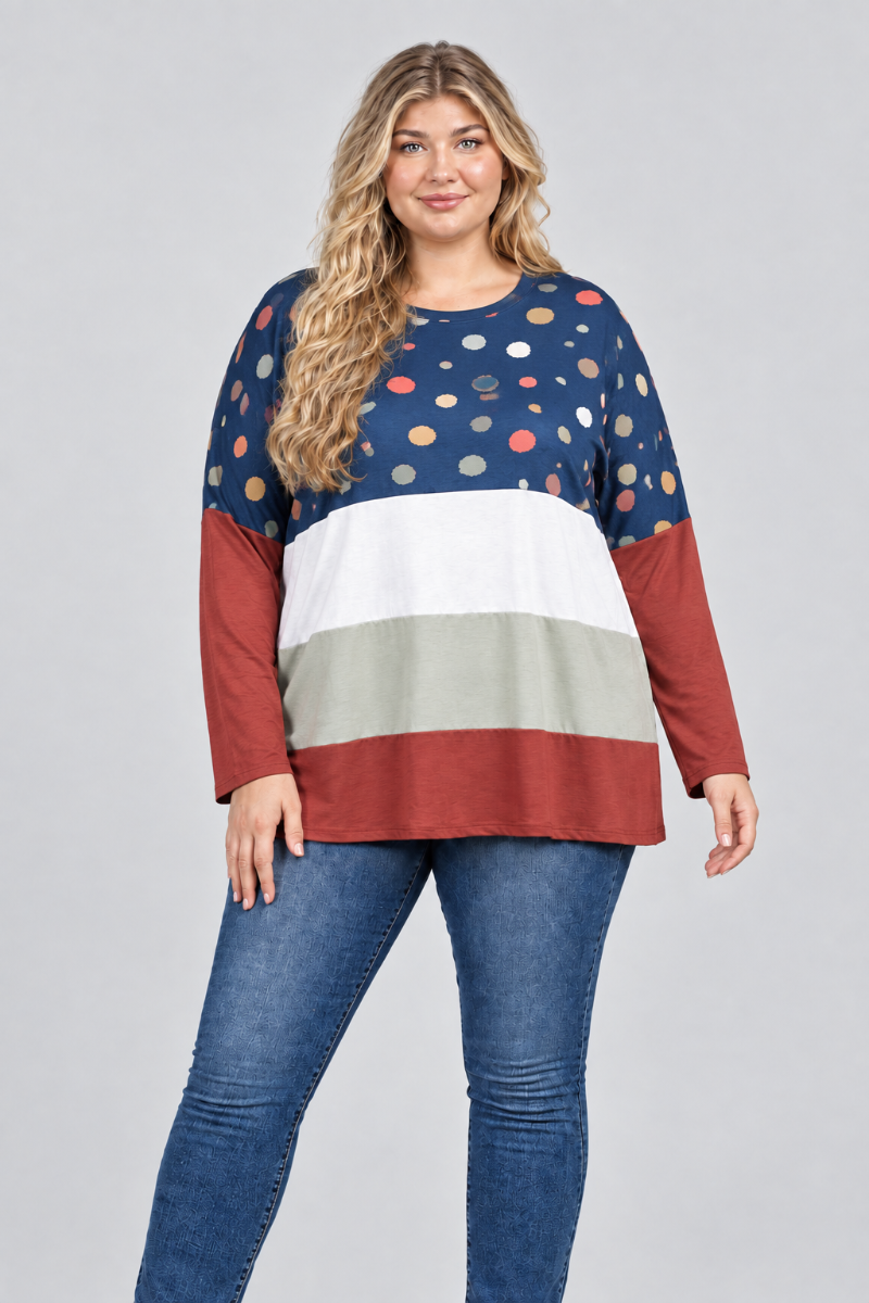 Hat-free studio front view of blonde model in navy dotted color-block tunic and blue jeans
