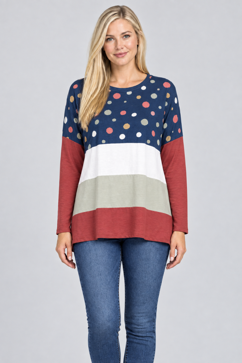 Hat-free studio front view of blonde model in navy dotted color-block tunic and jeans