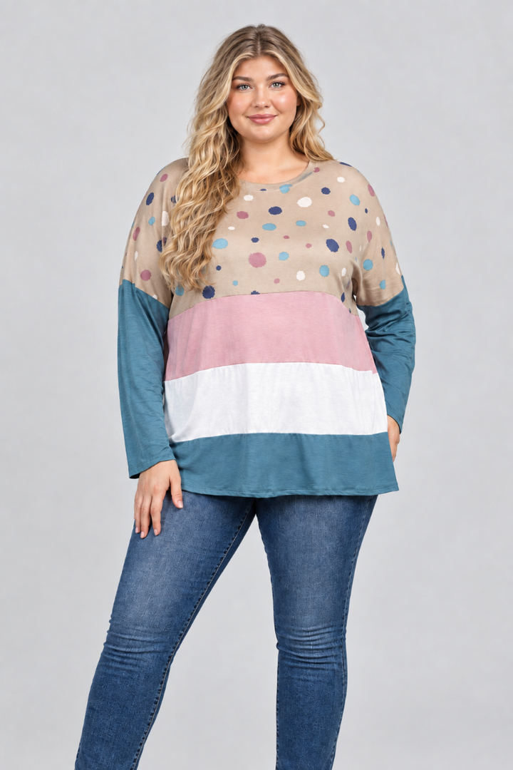 Hat-free studio front view of blonde model in taupe dotted color-block tunic and blue jeans