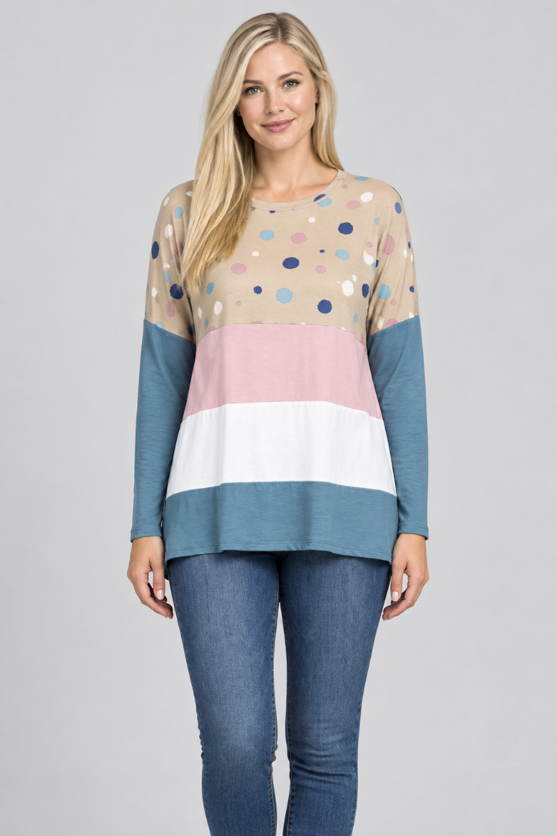 Hat-free studio front view of blonde model in taupe dotted color-block tunic and jeans
