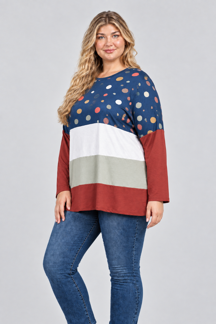 Hat-free studio side view of blonde model in navy dotted color-block tunic and blue jeans