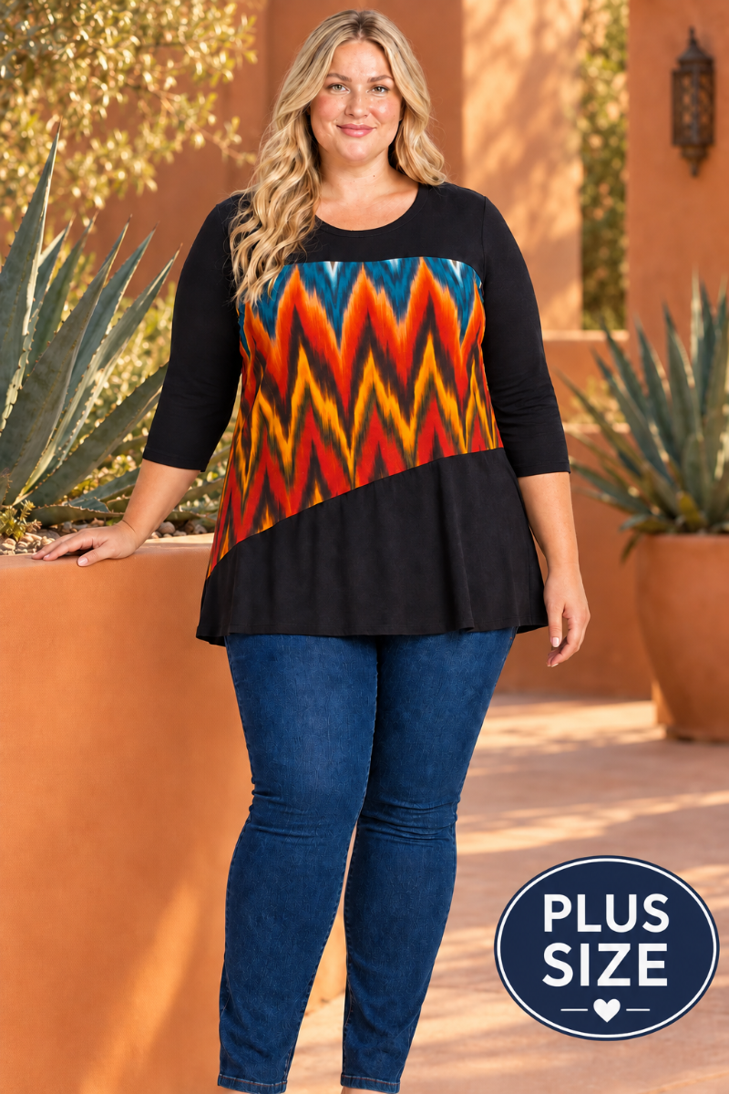 Lifestyle front view of blonde model in black tunic with colorful geometric panel, terracotta courtyard