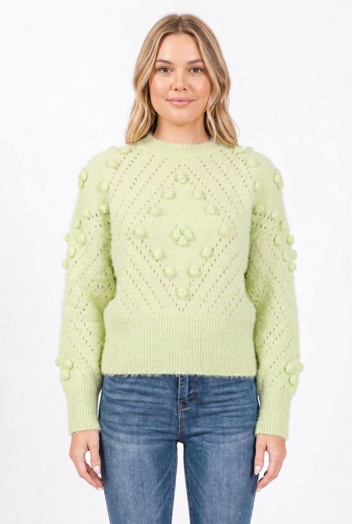 New-face blonde model wearing the pale green bobble-knit sweater