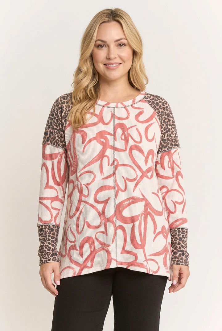 New regular-size blonde model wearing the heart-print and leopard-panel top