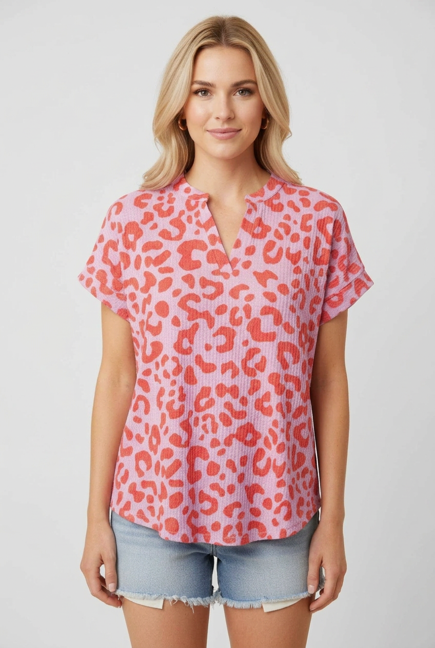 New regular-size blonde model wearing the pink and coral leopard-print top