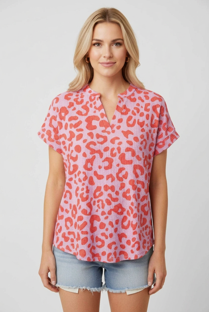 New regular-size blonde model wearing the pink and coral leopard-print top